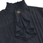 Black ruffled jabot shirt with ship wheel brooch, pleated front, worn | Chaps London