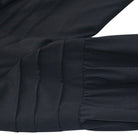Black ruffled cuff detail with pleated gathered fabric shown flat, close-up | Chaps London