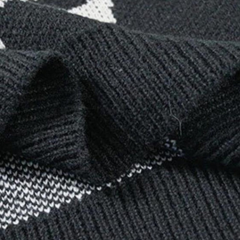 Close-up of black ribbed knit fabric folded showing jacquard pattern detail | Chaps London