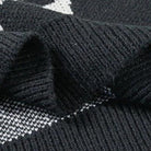 Close-up of black ribbed knit fabric folded showing jacquard pattern detail | Chaps London