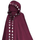 Burgundy hooded cloak with silver moon phase trim, worn by model | Chaps London