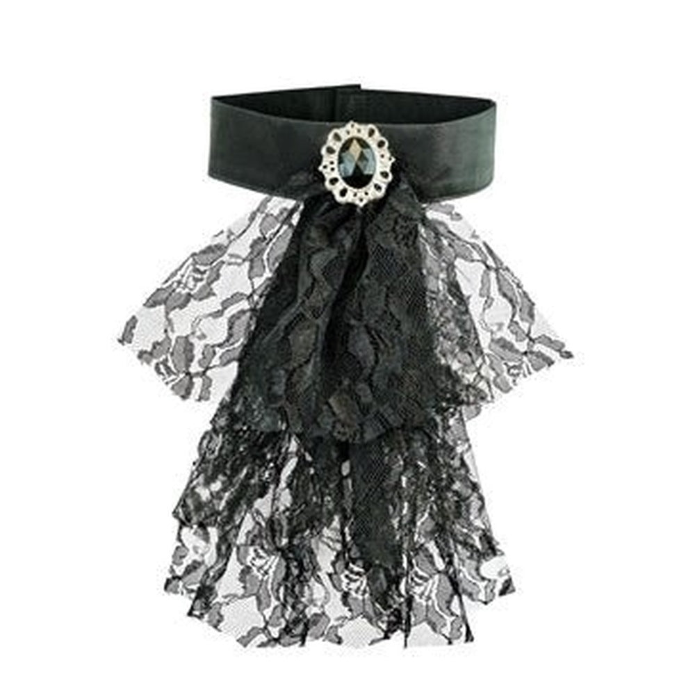 Black satin choker with layered lace ruffle and oval gemstone brooch, flat lay | Chaps London