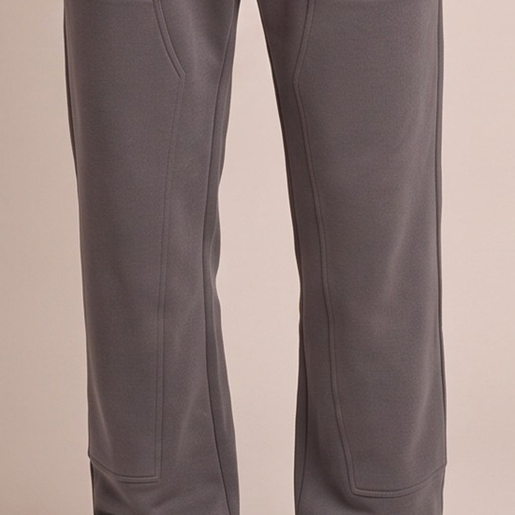 Dark grey jogger pants with stitched panels, worn by a person, cropped view | Chaps London