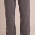 Dark grey jogger pants with stitched panels, worn by a person, cropped view | Chaps London