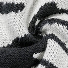 Close-up of black and white knit fabric with abstract pattern | Chaps London