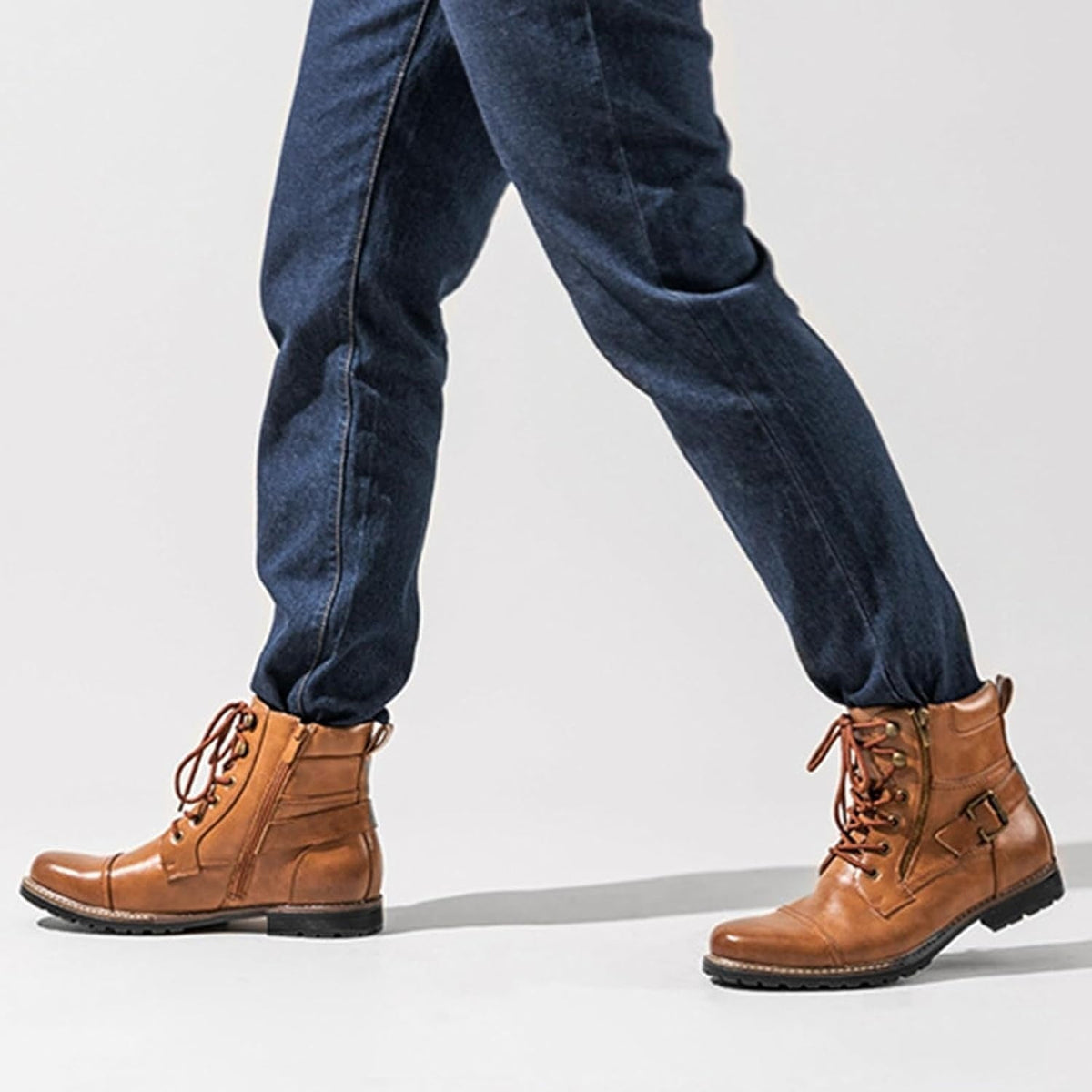 Man wearing brown leather lace-up boots with buckle strap and dark jeans | Chaps London