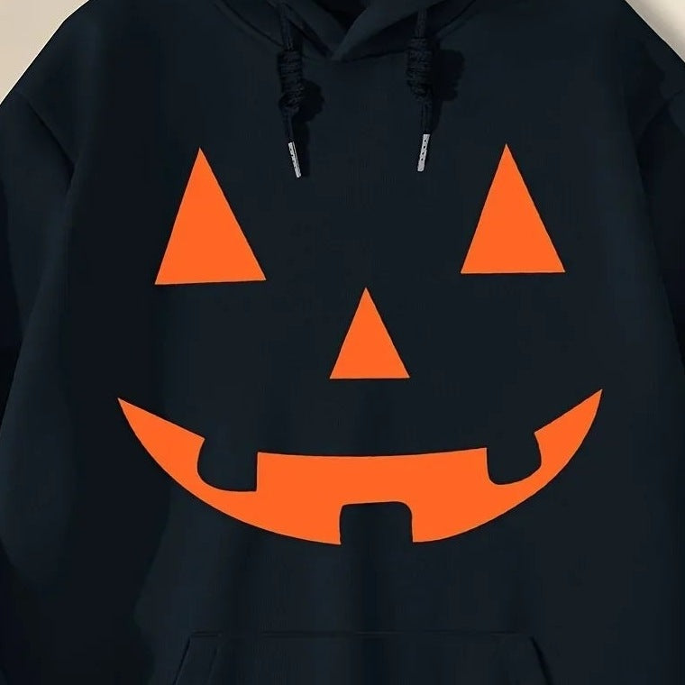 Black hoodie with orange jack-o-lantern face print, worn by a person | Chaps London