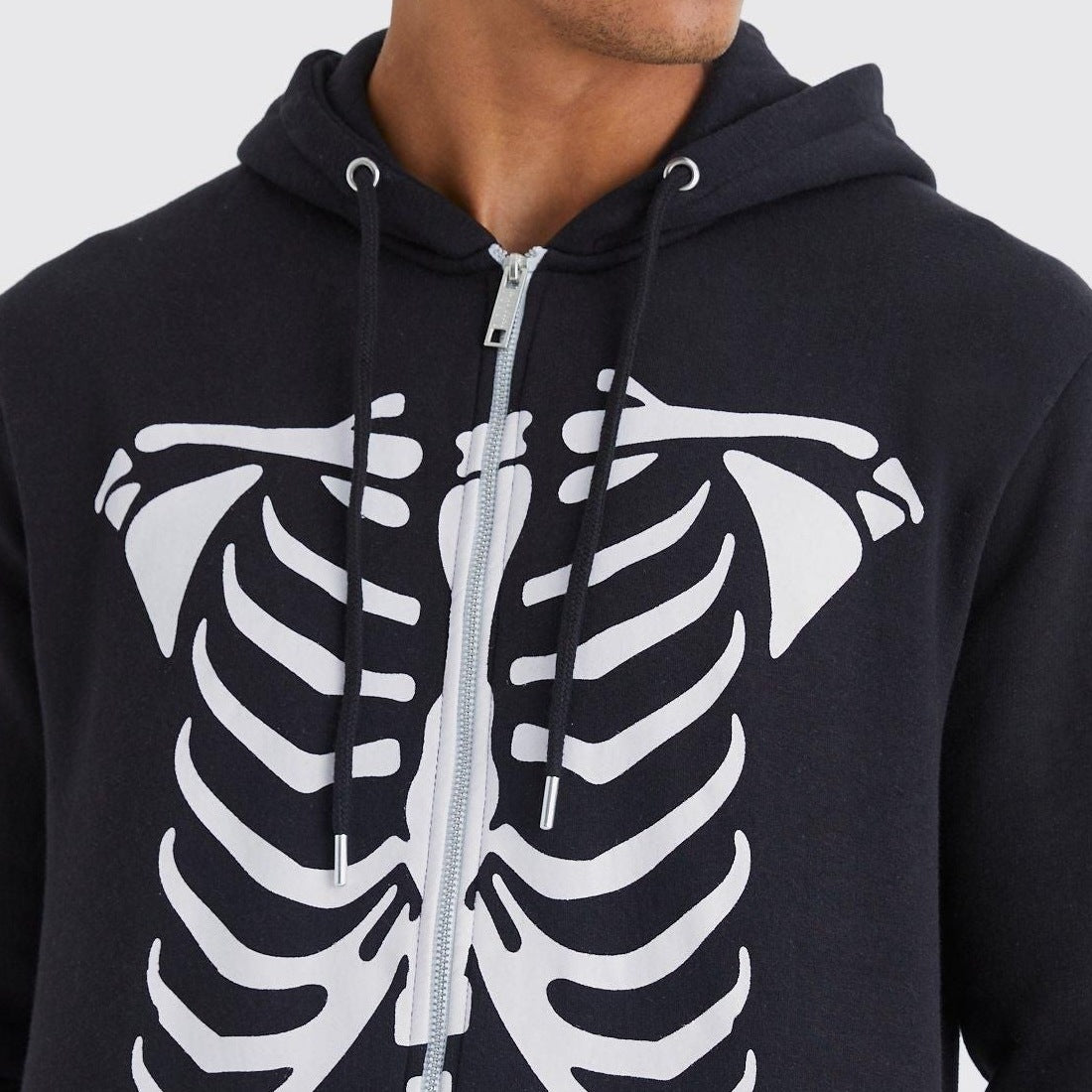 Black hooded zip-up with white skeleton rib cage print, worn by man | Chaps London