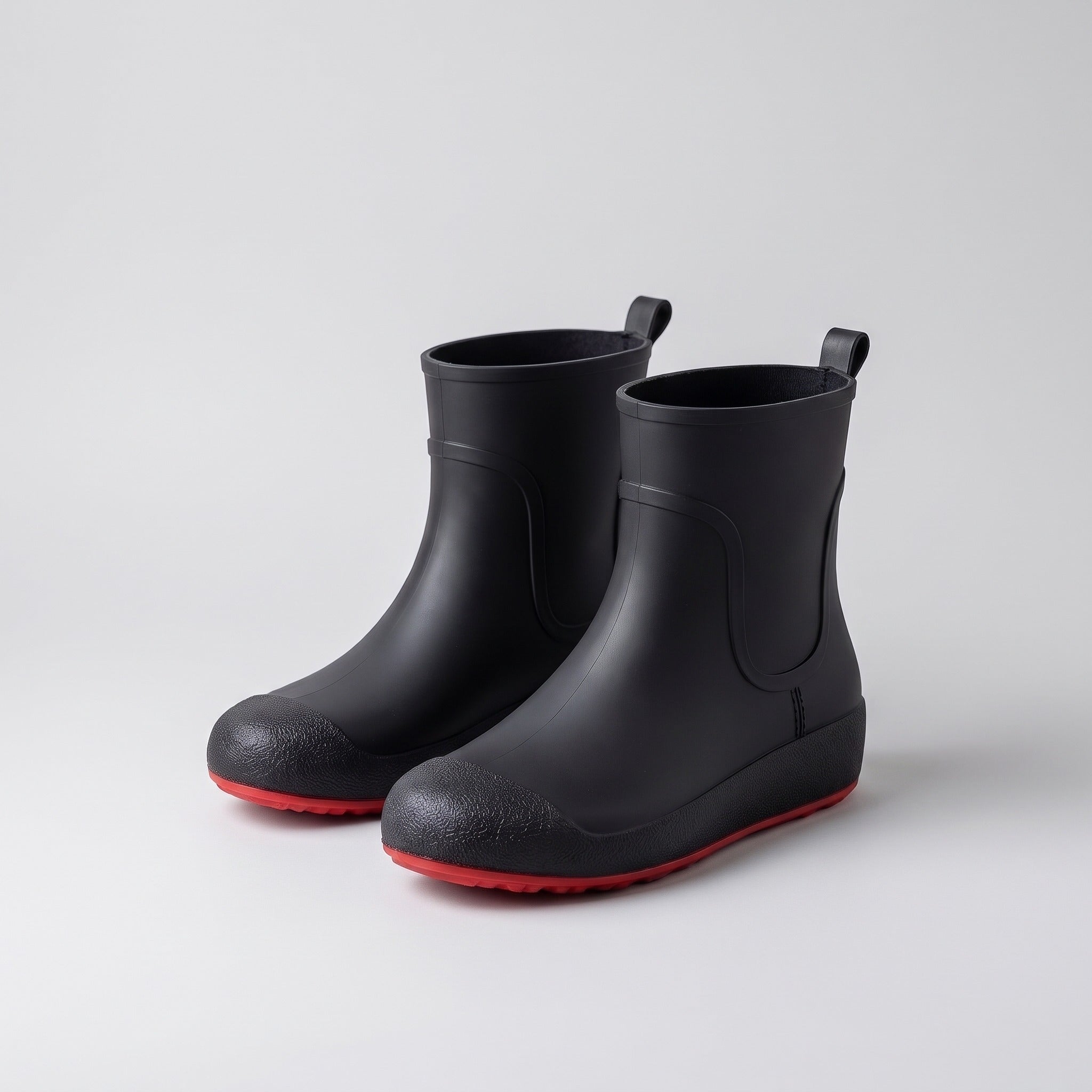 Black ankle wellies with red soles, shown as a pair, unworn | Chaps London