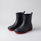 Black ankle wellies with red soles, shown as a pair, unworn | Chaps London