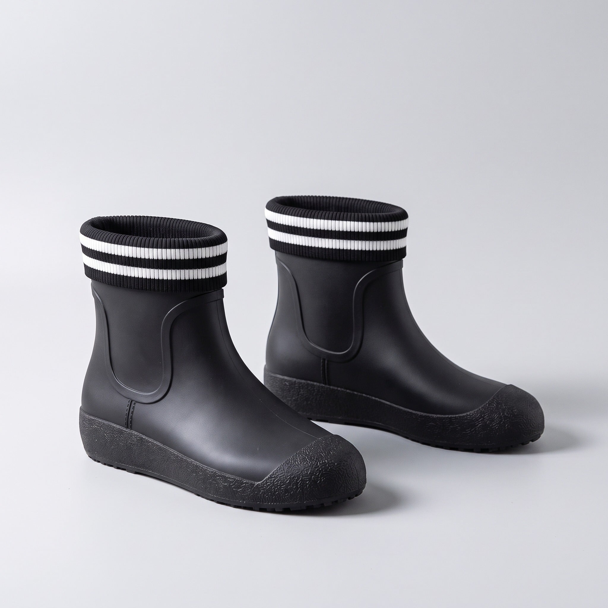 Black ankle wellies with striped knit cuffs, shown as a pair | Chaps London