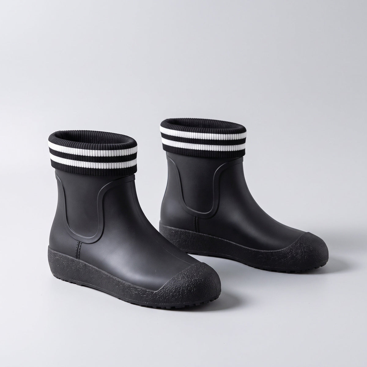Black ankle wellies with striped knit cuffs, shown as a pair | Chaps London