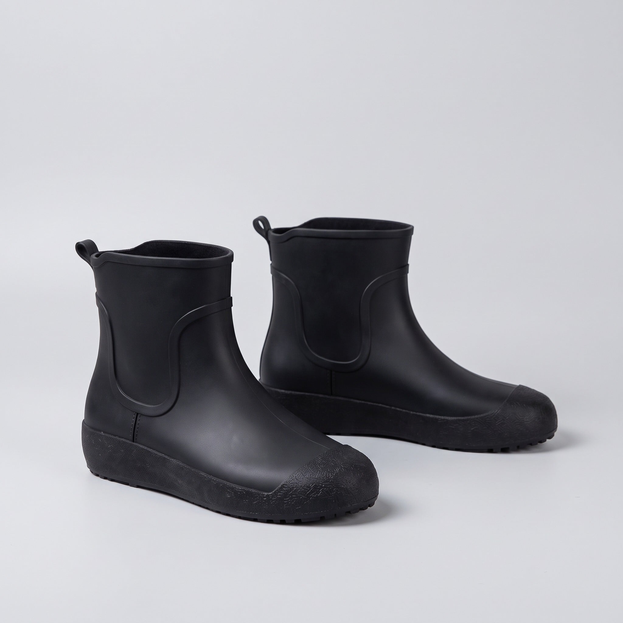 Pair of black ankle wellies shown standing on plain background | Chaps London