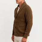 Man wearing brown ribbed knit shawl collar cardigan with buttons, side view | Chaps London