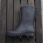Black mid-calf rain boot shown flat on wooden slats | Chaps London