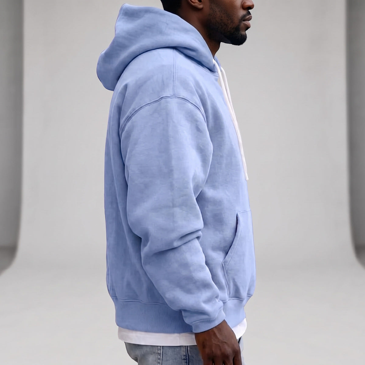 Man wearing light blue relaxed hoodie with white drawcords, side view | Chaps London