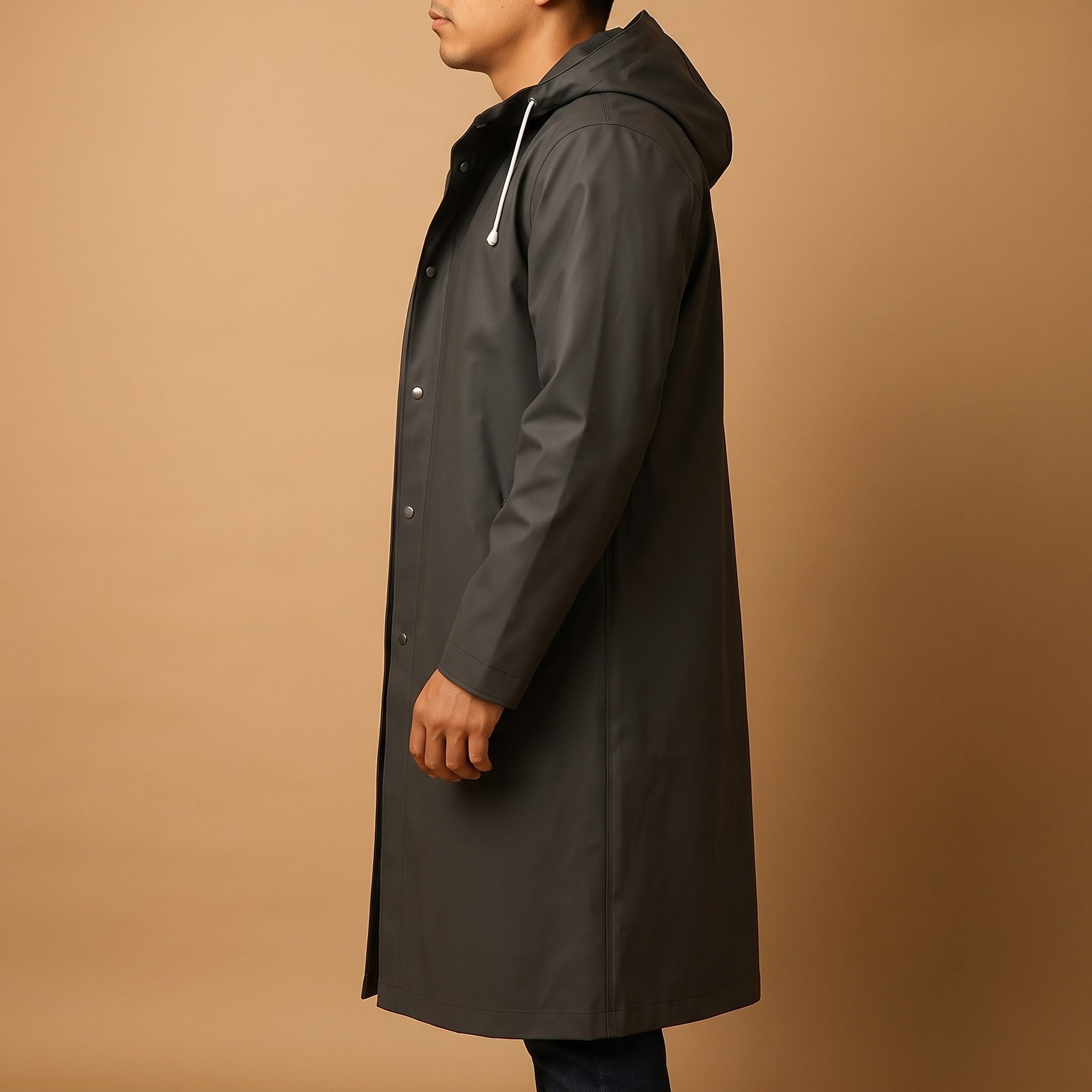 Man wearing dark green long hooded raincoat with snap front, side view | Chaps London