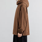 Brown waffle-texture hooded sweatshirt worn by man, side profile view | Chaps London