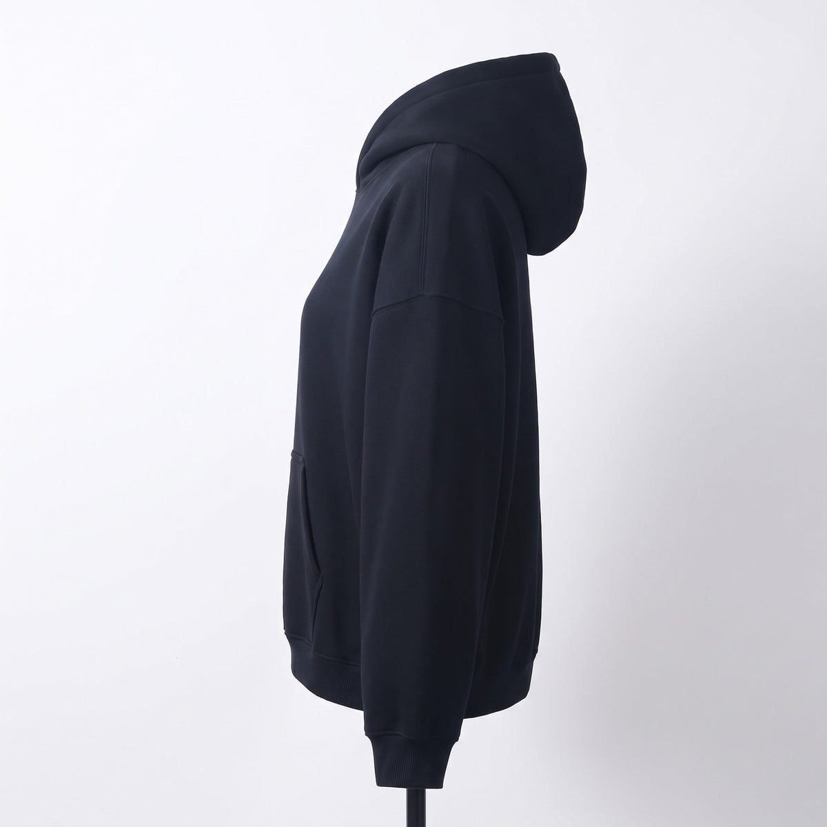 Black oversized hoodie with kangaroo pocket shown on mannequin, side view | Chaps London
