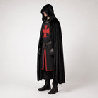 Man wearing black hooded cloak over red cross tunic costume | Chaps London