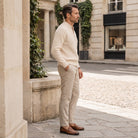 Man wearing cream ribbed zip cardigan with beige trousers on cobblestone street | Chaps London