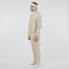 Man wearing cream mummy costume jumpsuit with frayed wraps and headband, side view | Chaps London
