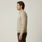 Man wearing beige textured knit half-zip polo jumper with dark trousers | Chaps London