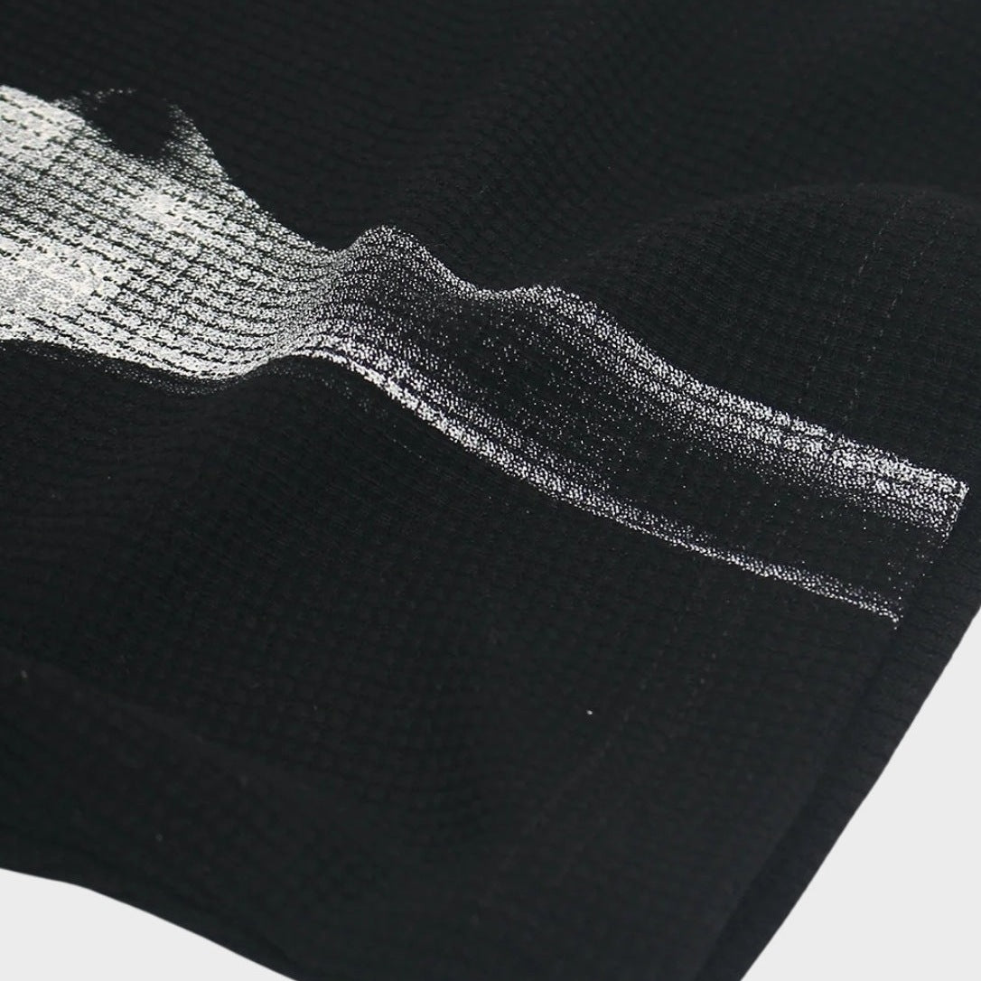 Black waffle-textured fabric close-up with silver skeleton ribcage print detail | Chaps London