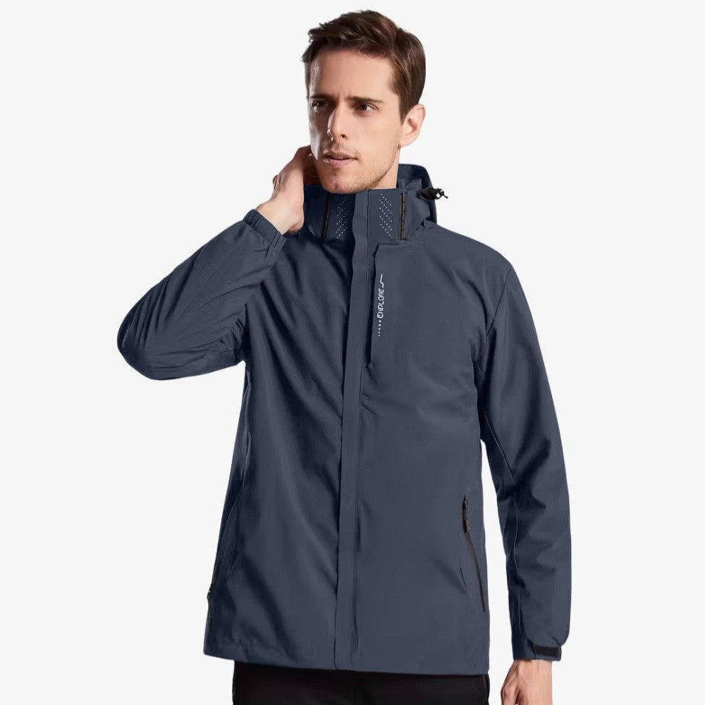 Man wearing slate blue hooded rain jacket with zippered pockets, front view | Chaps London