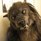 Brown werewolf mask with faux fur mane and fangs, worn by person | Chaps London