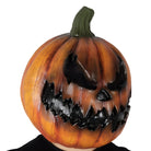 Orange pumpkin mask with evil carved face, worn by a person | Chaps London