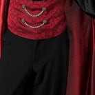 Red brocade waistcoat with chain detail worn over black trousers, red cape visible | Chaps London