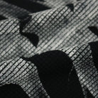 Close-up of black and white waffle-textured fabric with abstract pattern | Chaps London