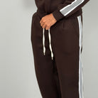 Dark brown wide-leg trousers with white side stripe, worn by person | Chaps London