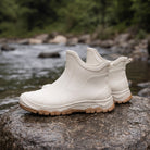 Cream short rain boots with treaded gum sole on wet rock | Chaps London