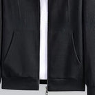 Black waffle-textured zip hoodie close-up showing pockets, zipper, and ribbed hem | Chaps London