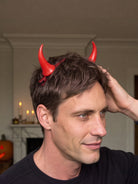 Model wearing the red devil horn clips in the hair