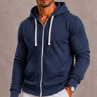 Man wearing heathered navy zip-up hoodie with white drawstrings, front pocket | Chaps London