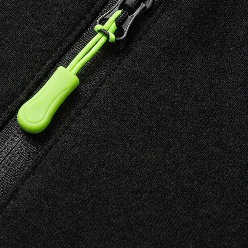 Close-up of black zip hoodie with green zipper pull, flat lay | Chaps London