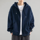 Navy blue zip-up hoodie worn by man, drawstring hood, layered over white shirt | Chaps London