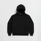 Black oversized hoodie with striped drawstring, laid flat, pouch pocket visible | Chaps London