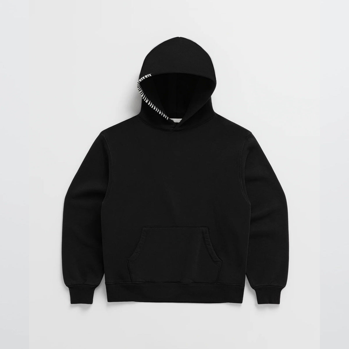 Black oversized hoodie with striped drawstring, laid flat, pouch pocket visible | Chaps London