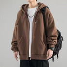Brown oversized zip hoodie worn by man with chain necklace and backpack | Chaps London