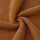Camel brown fleece fabric swatch twisted into spiral pattern, close-up texture | Chaps London