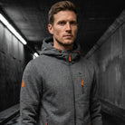 Man wearing dark grey zip hoodie with orange zipper pullers, hood up | Chaps London