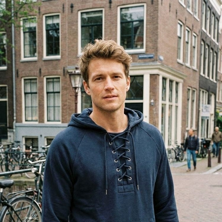Man wearing navy lace-up collar hoodie, standing on city street | Chaps London