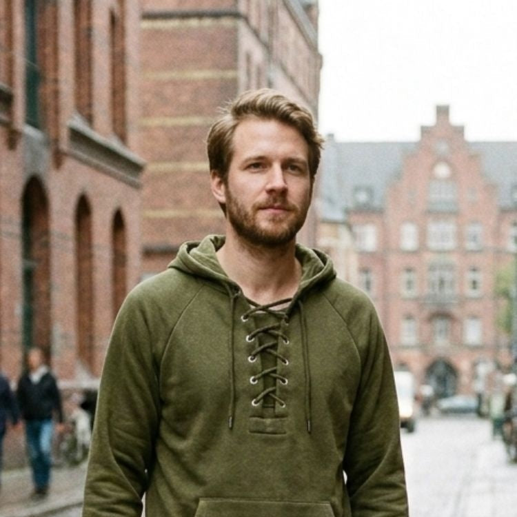 Man wearing olive green lace-up hoodie standing on city street | Chaps London