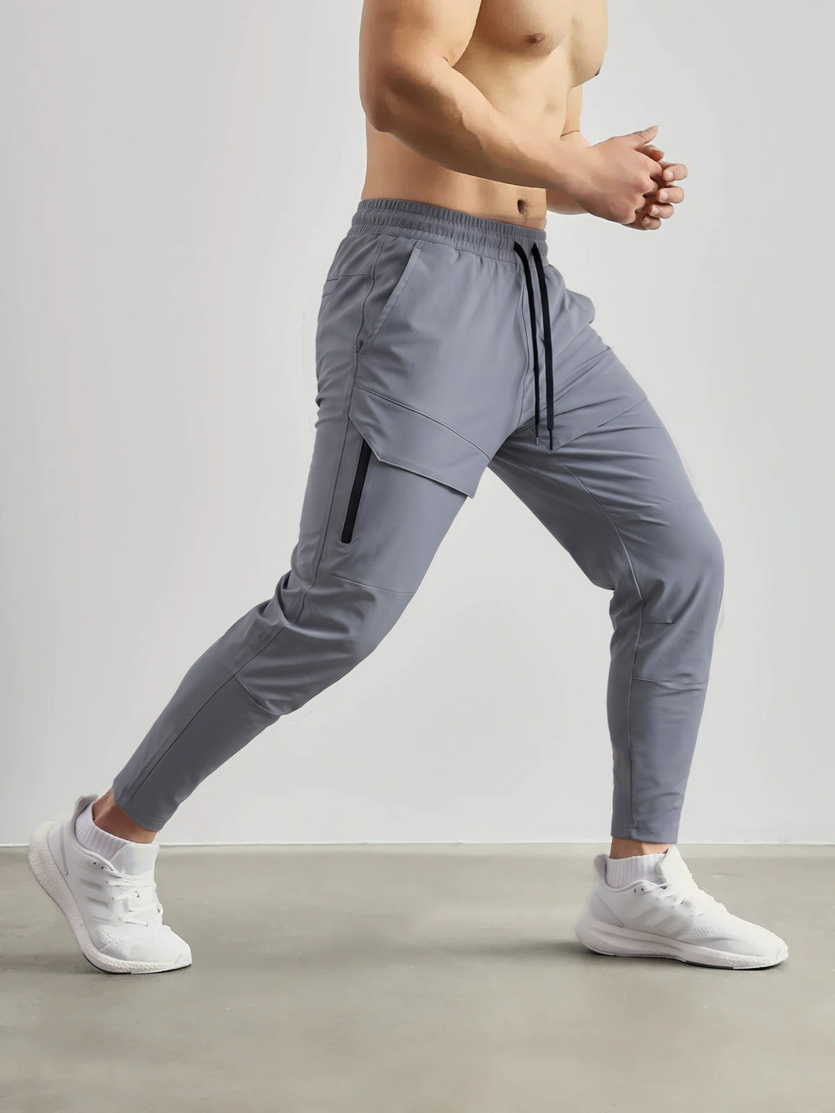 Gray zippered cargo joggers worn by man walking, side view | Chaps London