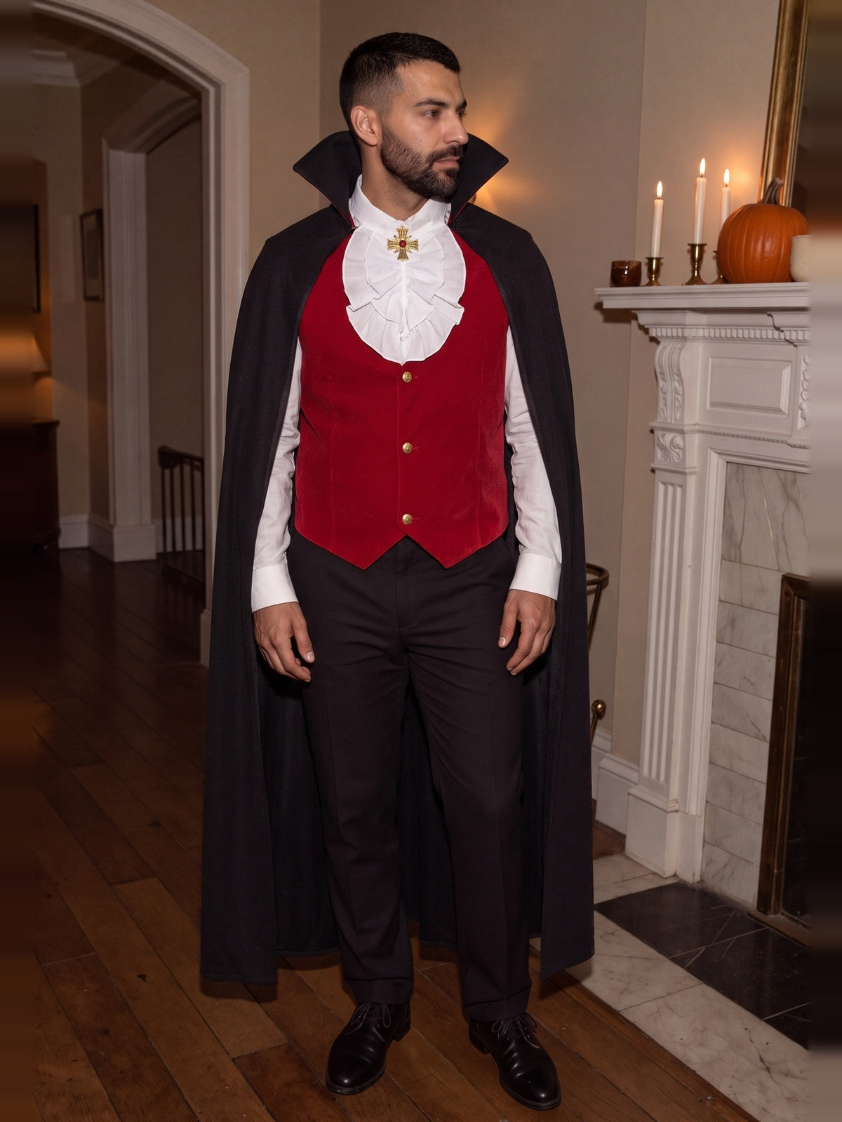 Man wearing the classic vampire costume with cape and red waistcoat